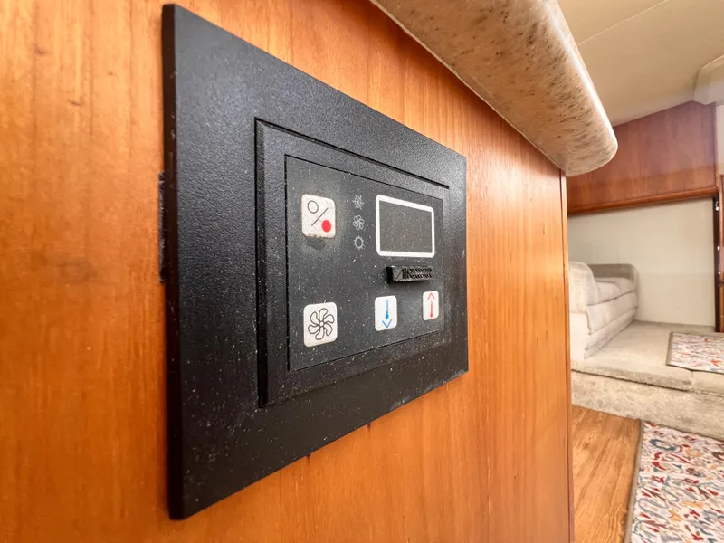 Slide: The Image of Control panel inside 2001 Silverton 352 Motor Yacht, wooden interior, and cozy seating area. - 21