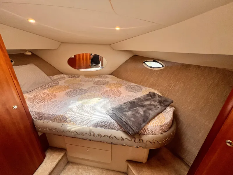 Slide: The Image of 2001 Silverton 352 Motor Yacht cozy bedroom with porthole windows and patterned bedding. - 23
