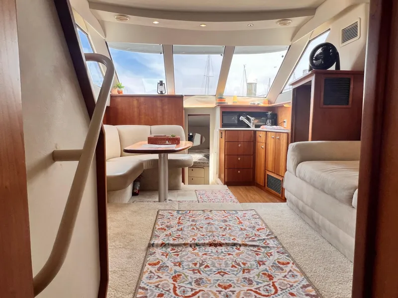 Slide: The Image of Interior of 2001 Silverton 352 Motor Yacht with seating, table, and kitchenette. - 24