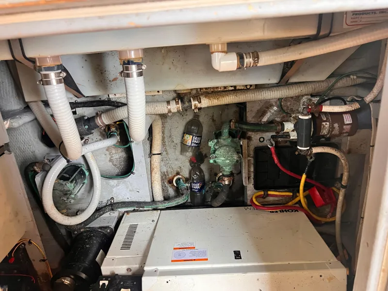 Slide: The Image of Engine compartment of a 2001 Silverton 352 Motor Yacht with various mechanical components and wiring. - 33