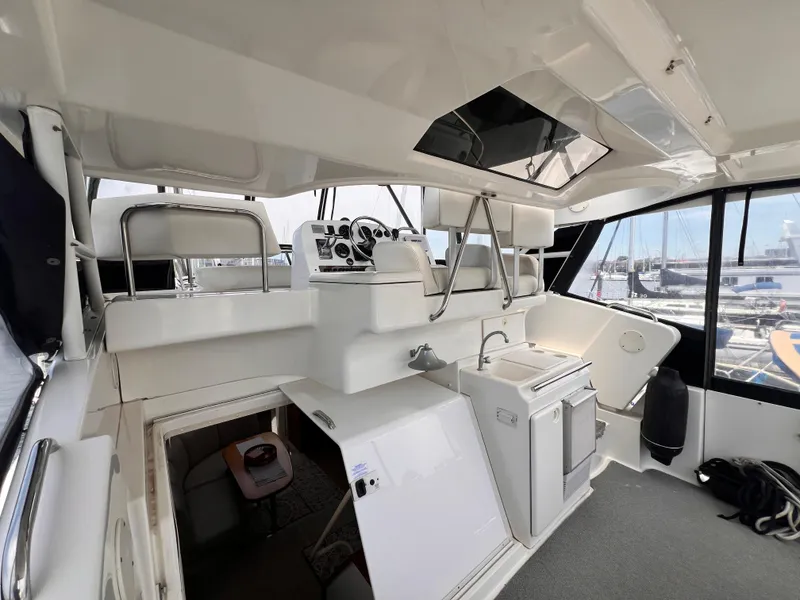 Slide: The Image of 2001 Silverton 352 Motor Yacht interior with helm, seating, and kitchenette. - 34