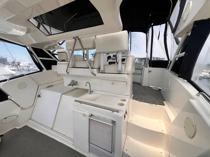 Slide: The Image of 2001 Silverton 352 Motor Yacht interior with helm, sink, and seating area. - 35