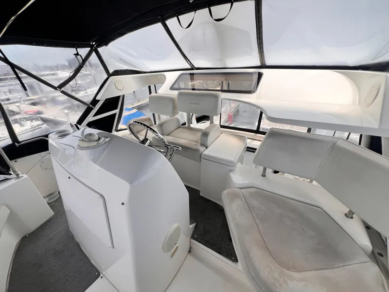 Slide: The Image of 2001 Silverton 352 Motor Yacht interior helm with seating and steering wheel. - 38