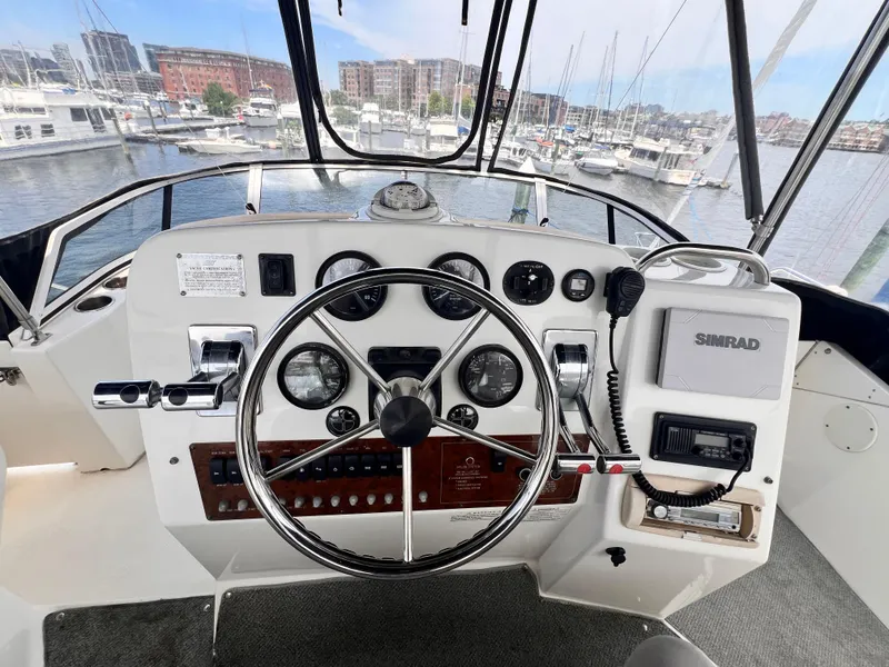 Slide: The Image of Helm of 2001 Silverton 352 Motor Yacht with steering wheel and navigation instruments. - 40