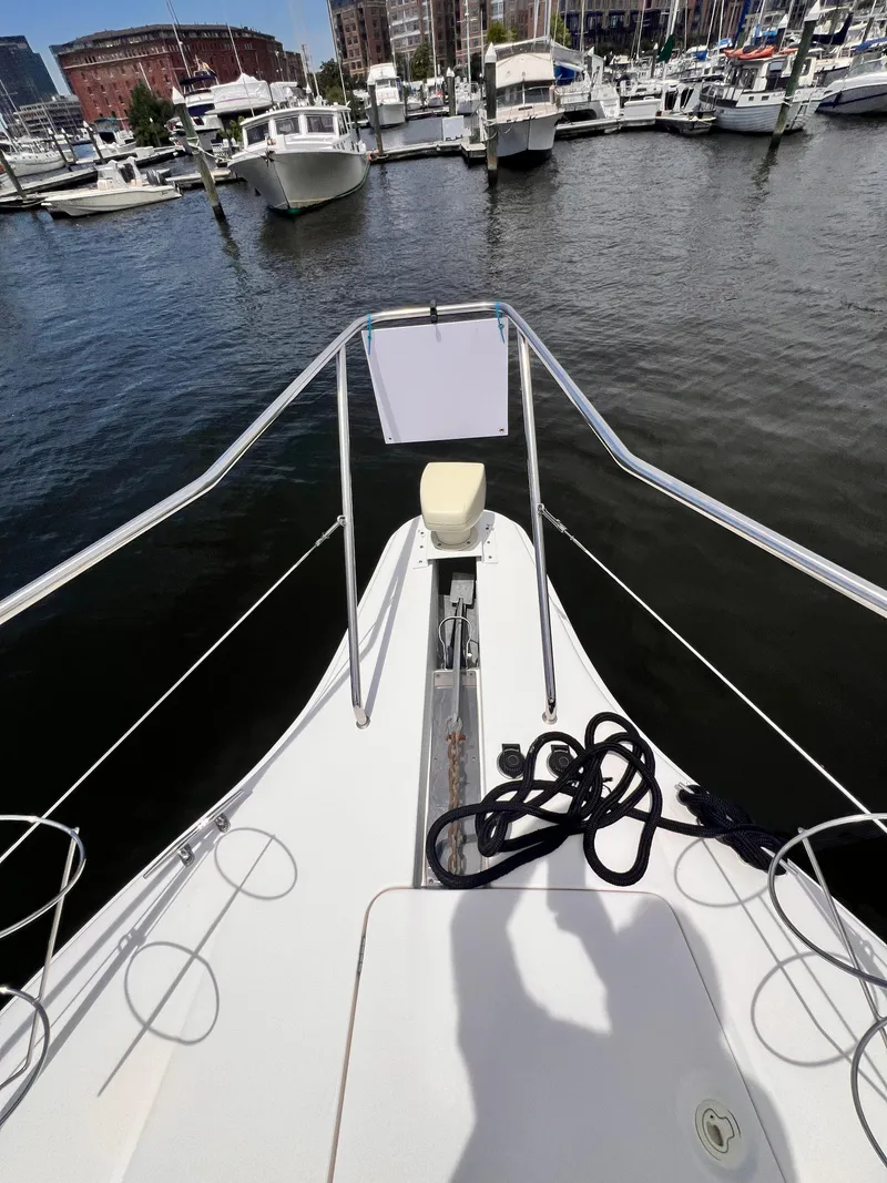 Slide: The Image of Bow of a 2001 Silverton 352 Motor Yacht docked at a marina. - 49
