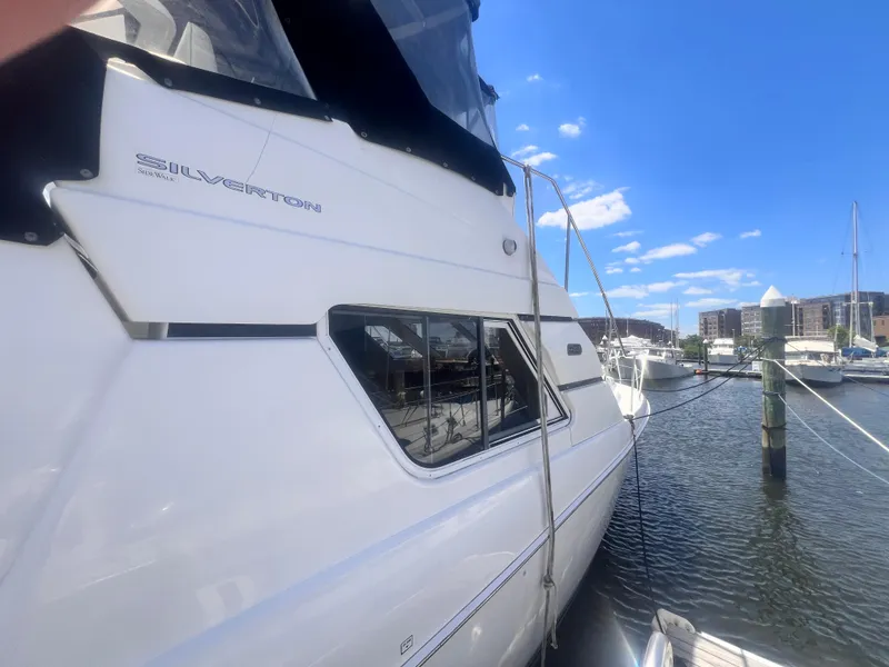 Slide: The Image of 2001 Silverton 352 Motor Yacht docked at a marina on a sunny day. - 6