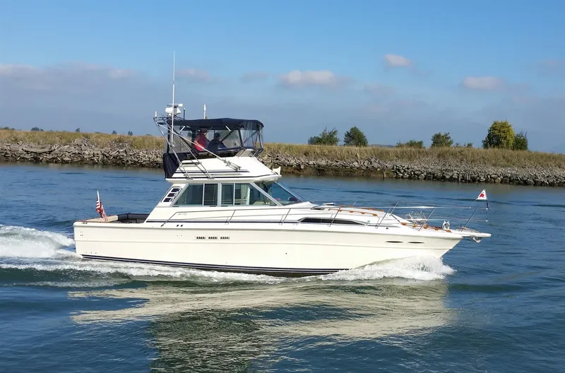 Slide: The Image of 1985 Sea Ray 390 Sedan Bridge cruising on a sunny day. - 0