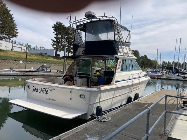 Slide: The Image of 1985 Sea Ray 390 Sedan Bridge docked at marina, named Sea Nile. - 2