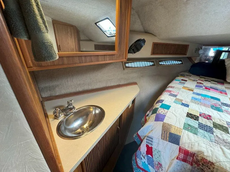 Slide: The Image of 1985 Sea Ray 390 Sedan Bridge cabin with sink and bed. - 27