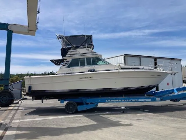 Slide: The Image of 1985 Sea Ray 390 Sedan Bridge on trailer at maritime service facility. - 3