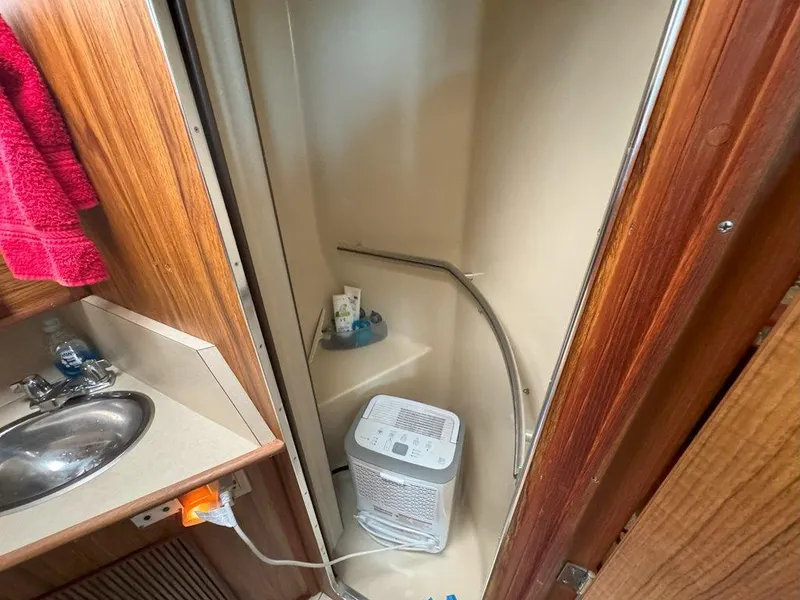 Slide: The Image of 1985 Sea Ray 390 Sedan Bridge bathroom with sink and shower. - 30