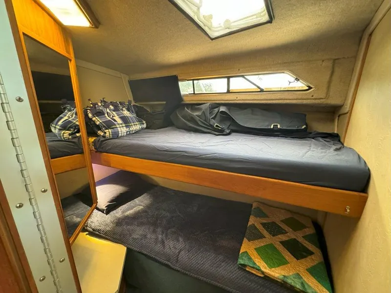 Slide: The Image of Cozy cabin interior of a 1985 Sea Ray 390 Sedan Bridge with bunk beds and skylight. - 31