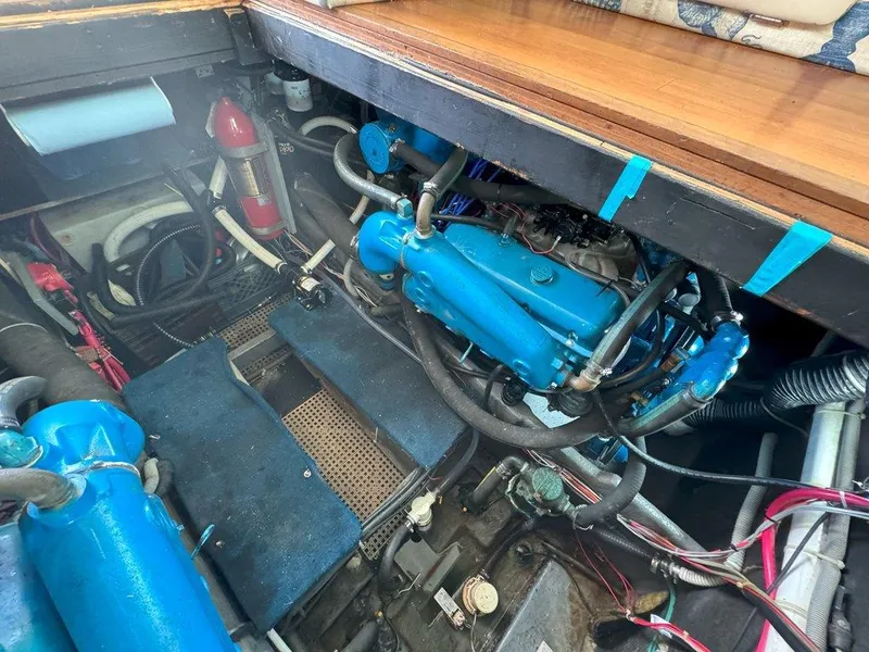 Slide: The Image of Engine room of a 1985 Sea Ray 390 Sedan Bridge with blue engine components. - 36