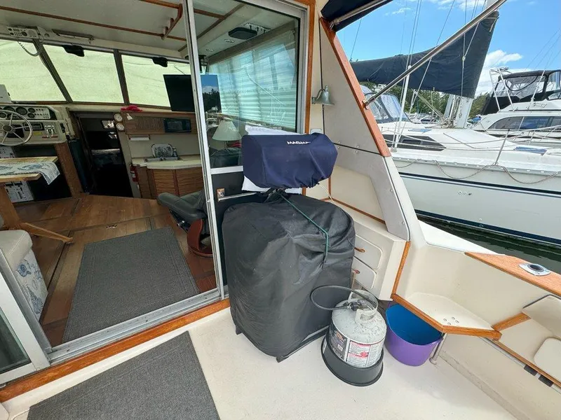 Slide: The Image of 1985 Sea Ray 390 Sedan Bridge interior with marina view. - 6