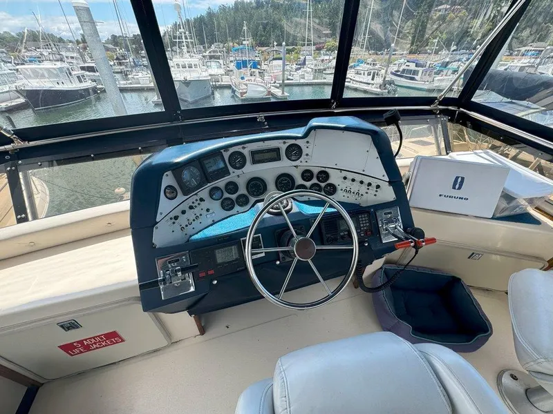 Slide: The Image of 1985 Sea Ray 390 Sedan Bridge helm with marina view. - 8