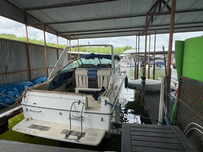 Slide: The Image of 1988 Sea Ray Sundancer 268 docked in a covered marina. - 2
