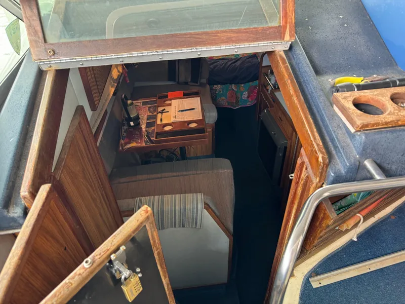 Slide: The Image of 1988 Sea Ray Sundancer 268 cabin interior with seating and table. - 7