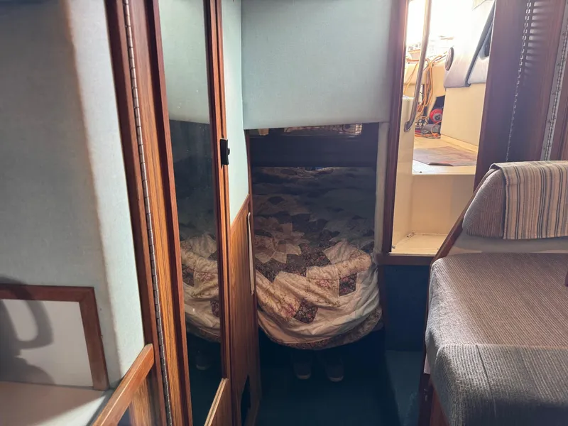 Slide: The Image of Interior cabin of 1988 Sea Ray Sundancer 268 with bed and seating area. - 9