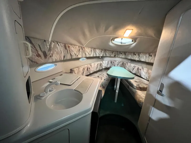 Slide: The Image of Interior of 1994 Chris-Craft 262 Crowne boat with kitchenette and seating area. - 10