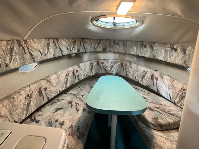 Slide: The Image of 1994 Chris-Craft 262 Crowne cabin interior with seating and table. - 11
