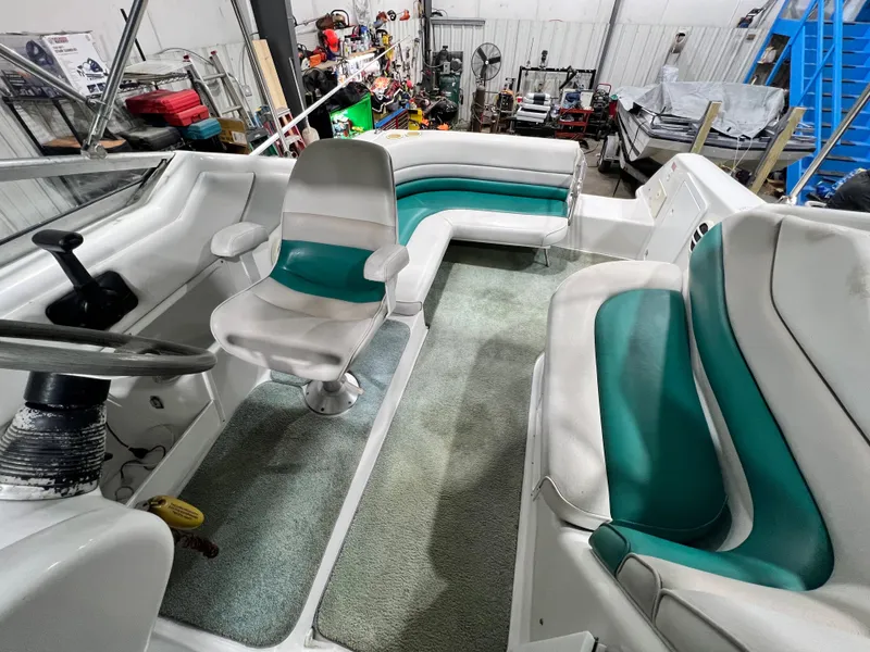 Slide: The Image of 1994 Chris-Craft 262 Crowne boat interior with white and teal seating. - 7