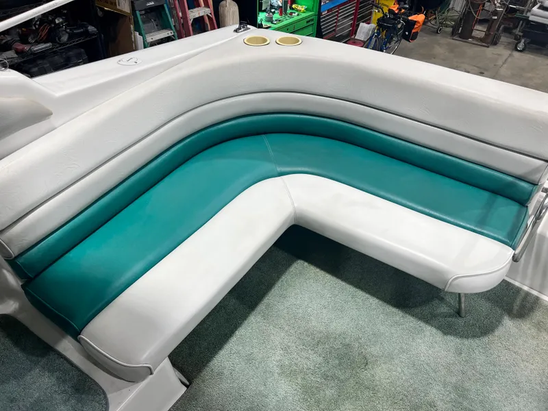 Slide: The Image of 1994 Chris-Craft 262 Crowne boat interior with teal and white seating. - 8