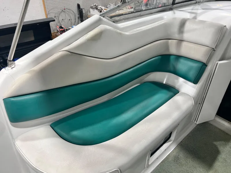 Slide: The Image of 1994 Chris-Craft 262 Crowne boat interior seating with teal and white upholstery. - 9