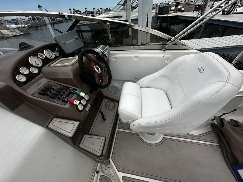 Slide: The Image of 2005 Regal Commodore 27 boat cockpit with steering wheel and control panel at marina. - 10