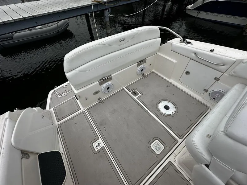 Slide: The Image of 2005 Regal Commodore 27 boat interior with white seating and storage compartments. - 12