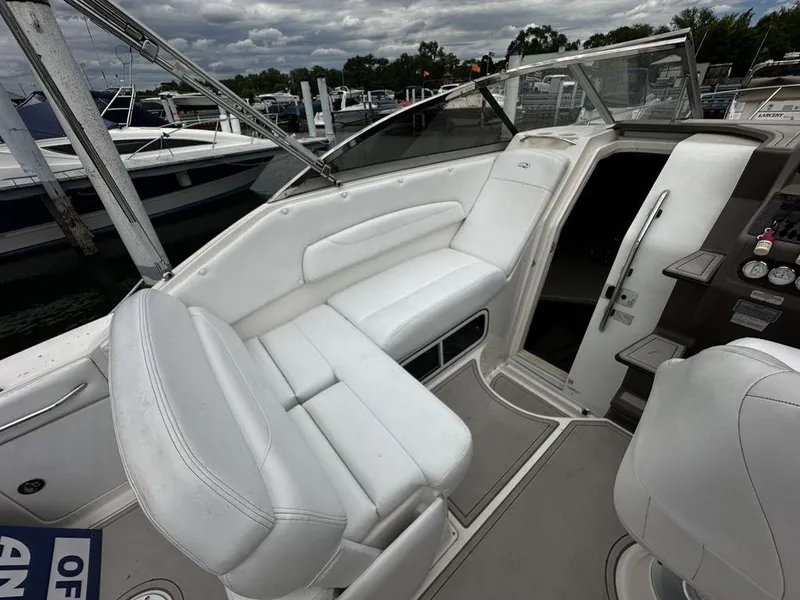Slide: The Image of 2005 Regal Commodore 27 boat interior with white seating and dashboard. - 17
