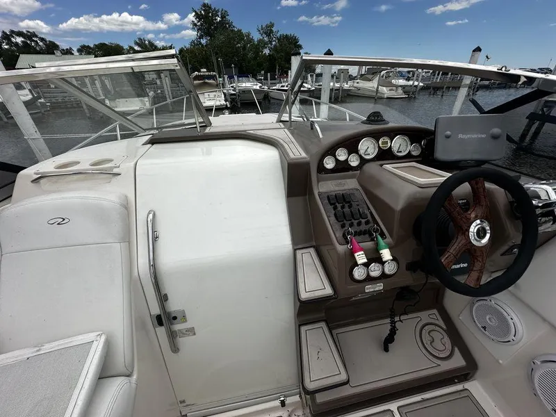 Slide: The Image of Cockpit of 2005 Regal Commodore 27 boat with steering wheel and control panel. - 19