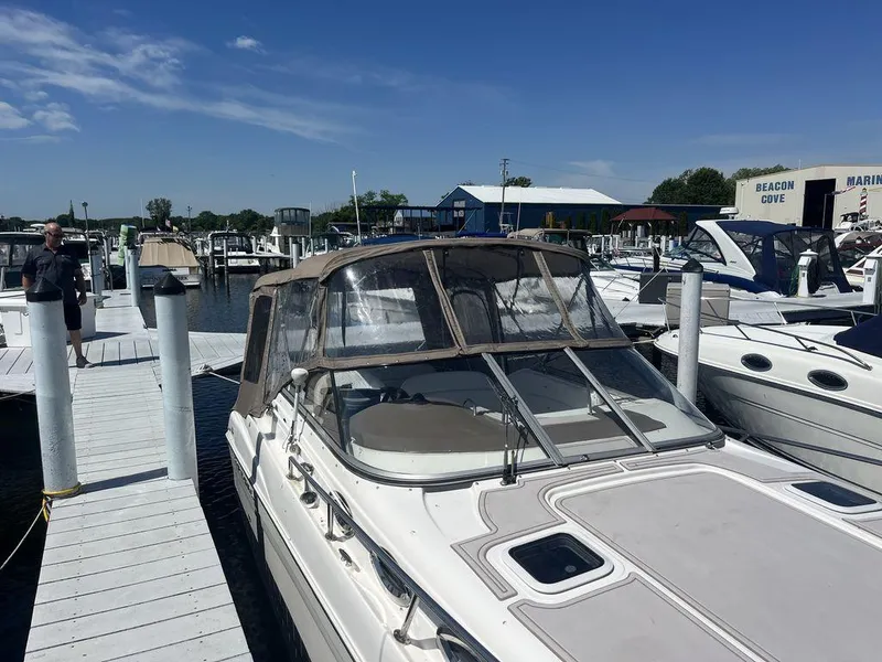 Slide: The Image of 2005 Regal Commodore 27 docked at marina with clear blue sky. - 2