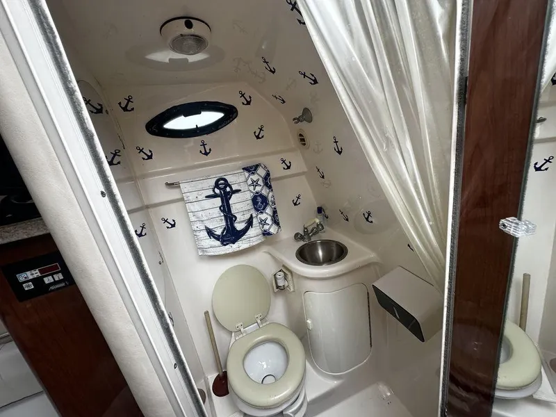 Slide: The Image of 2005 Regal Commodore 27 boat bathroom with nautical anchor decor. - 21