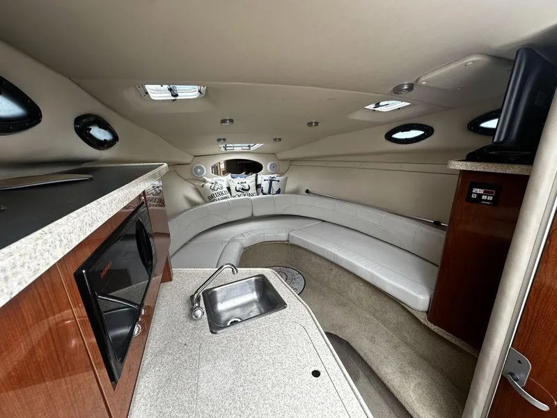 Slide: The Image of Interior of 2005 Regal Commodore 27 boat with kitchenette and seating area. - 24