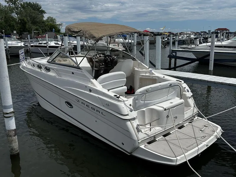 Slide: The Image of 2005 Regal Commodore 27 boat docked at a marina with canopy. - 4