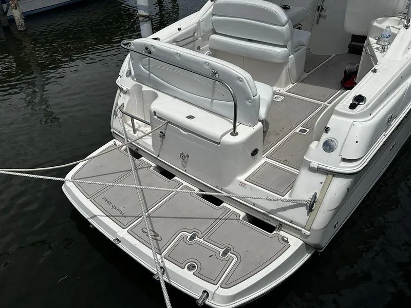 Slide: The Image of 2005 Regal Commodore 27 boat docked, showing spacious deck and seating area. - 8