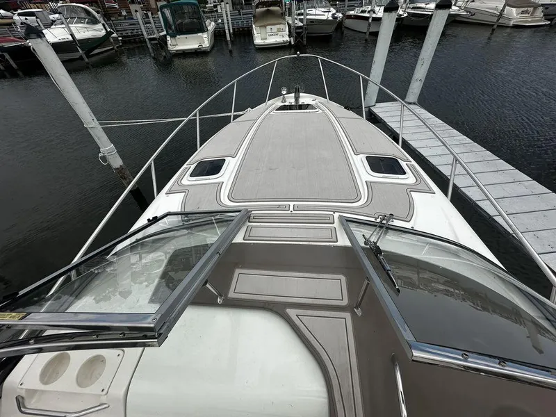 Slide: The Image of 2005 Regal Commodore 27 boat docked at a marina, view from the bow. - 9