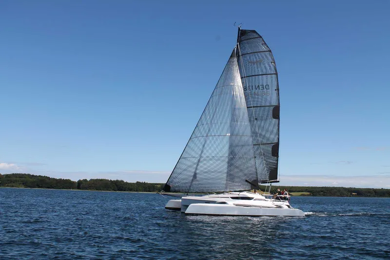 Slide: The Image of Sailing on calm waters, the 2026 Dragonfly 28 trimaran showcases sleek design and performance. - 1