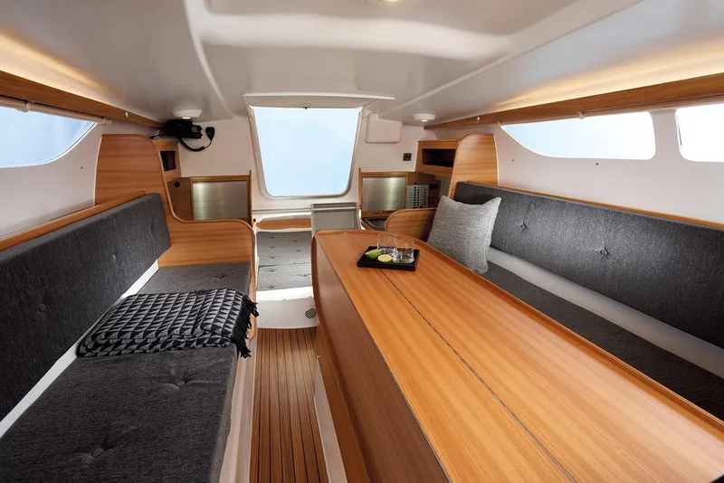 Slide: The Image of Interior of 2026 Dragonfly 28 sailboat, featuring sleek wood finishes and modern seating. - 4