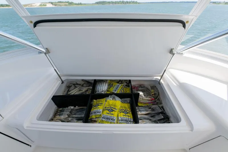 Slide: The Image of Open storage compartment on 2017 Viking 72 Convertible boat filled with fishing bait. - 20