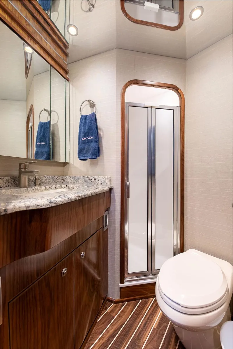 Slide: The Image of 2017 Viking 72 Convertible yacht bathroom with shower, vanity, and toilet. - 35