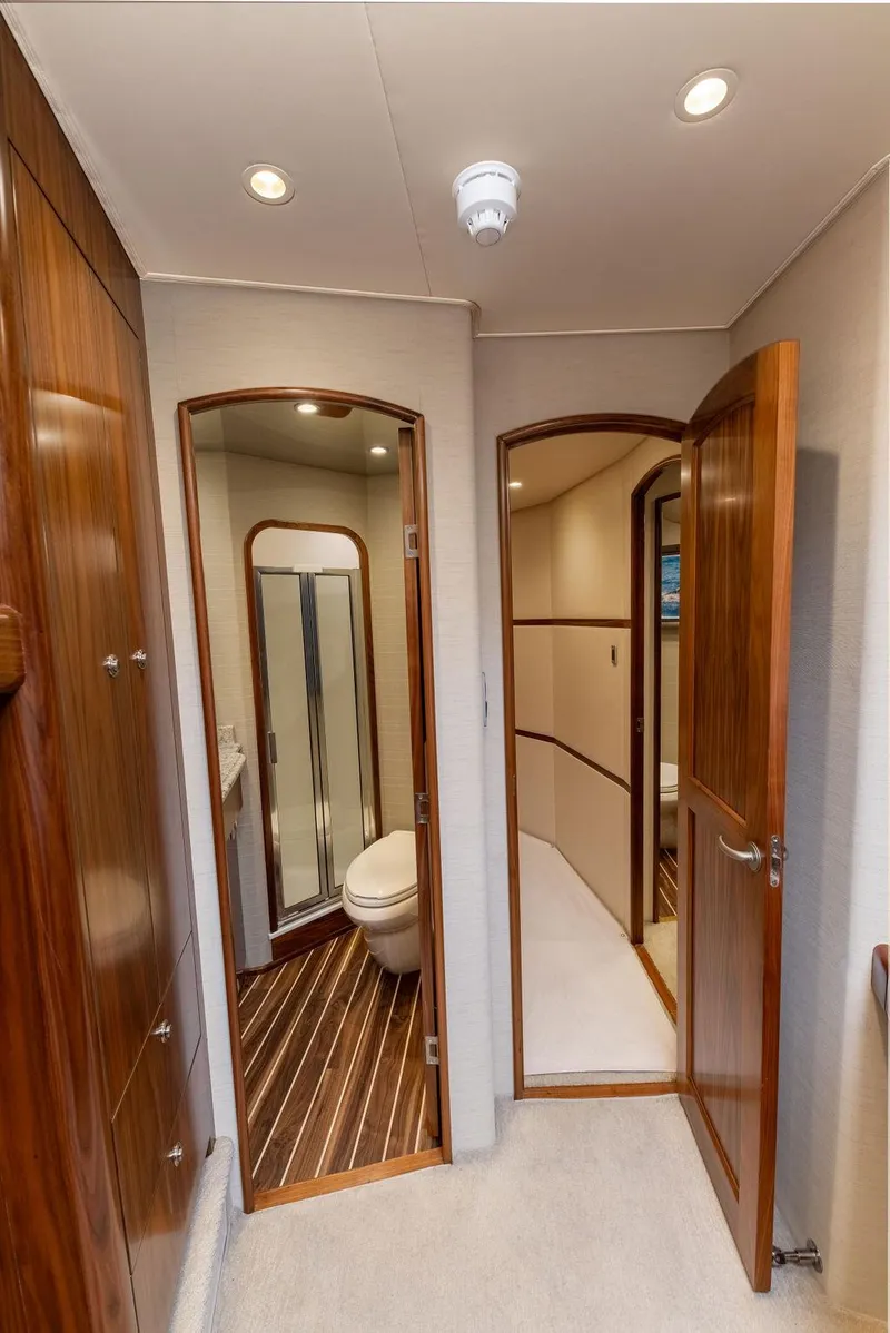 Slide: The Image of 2017 Viking 72 Convertible yacht interior with wooden doors and bathroom. - 37