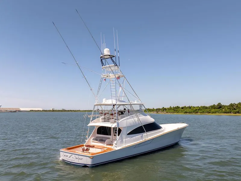 Slide: The Image of 2017 Viking 72 Convertible yacht on calm waters with clear sky. - 4