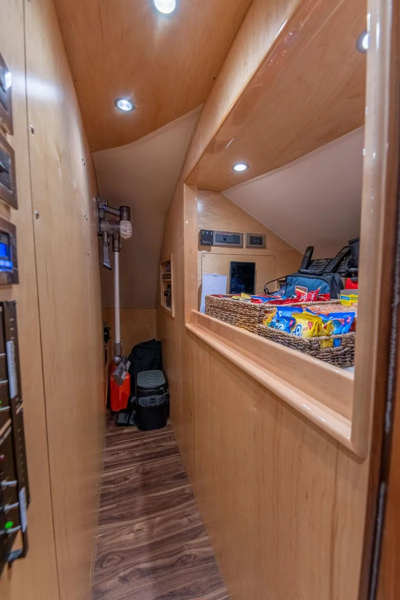 Slide: The Image of Interior hallway of 2017 Viking 72 Convertible yacht with wooden paneling and storage. - 41