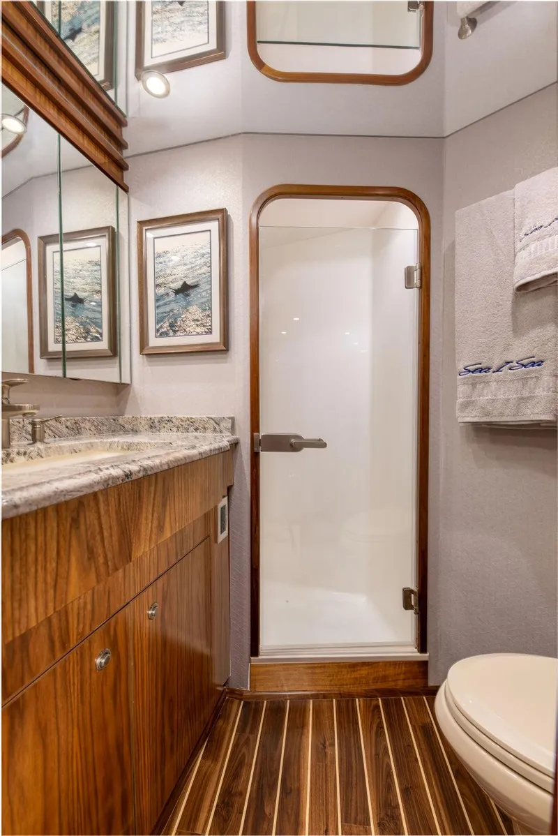 Slide: The Image of Luxurious bathroom in 2017 Viking 72 Convertible yacht with wood accents and modern fixtures. - 45