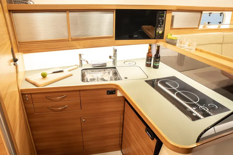 Slide: The Image of Modern kitchen in 2026 Dragonfly 40 yacht with sleek wood cabinetry and induction cooktop. - 10