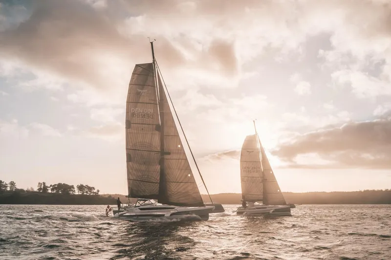 Slide: The Image of Sailboats on water at sunset, featuring Dragonfly 40 model, 2026. - 2