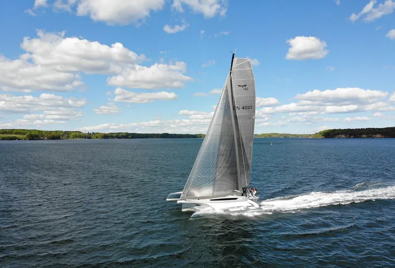Slide: The Image of Sleek Dragonfly 40 sailboat gliding on open water under a clear blue sky, 2026 model. - 7