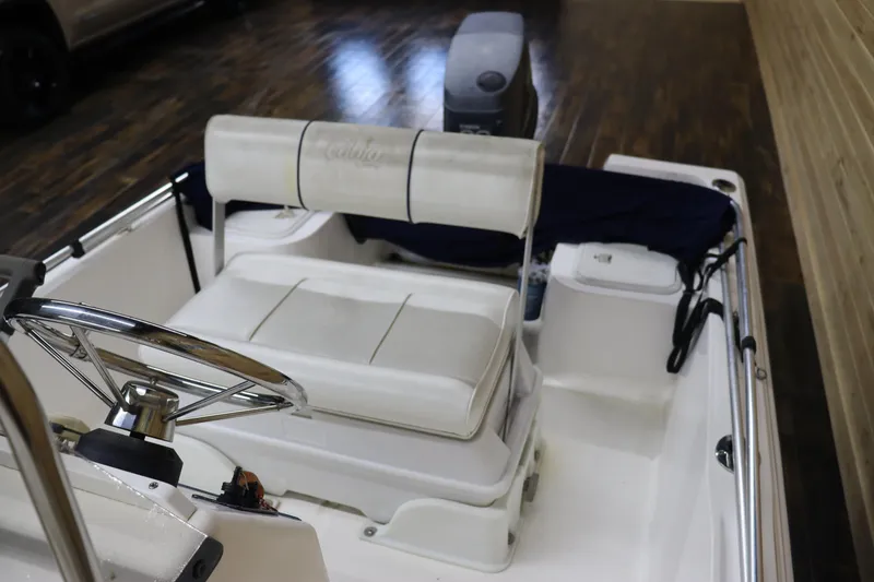 Slide: The Image of 2002 Cobia 174 Center Console boat interior with steering wheel and seating. - 12