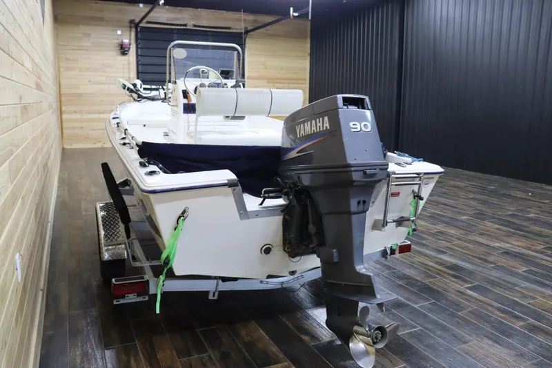 Slide: The Image of 2002 Cobia 174 Center Console boat with Yamaha 90 outboard motor in indoor storage. - 5